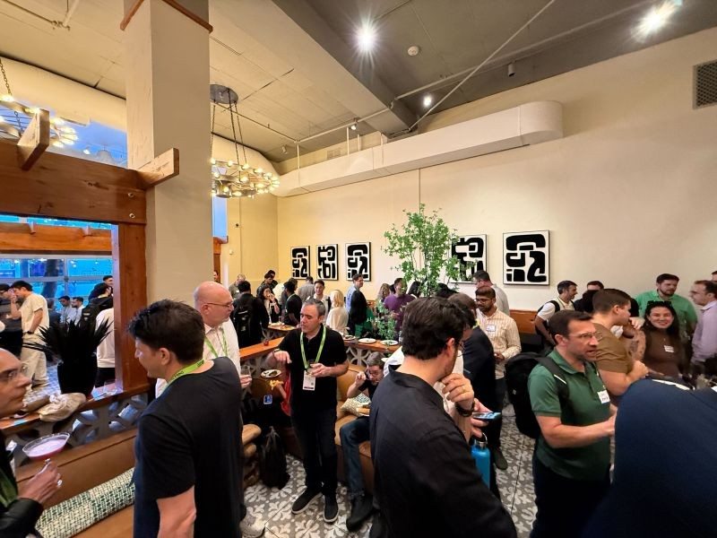 Attendees talking in a crowded venue at a developer gathering around GTC.