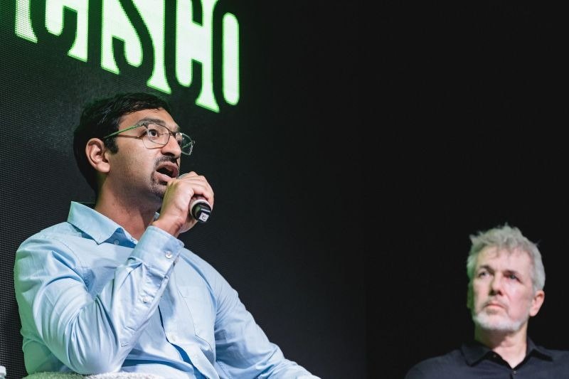 A panelist speaking into a handheld microphone on the Step SF stage.